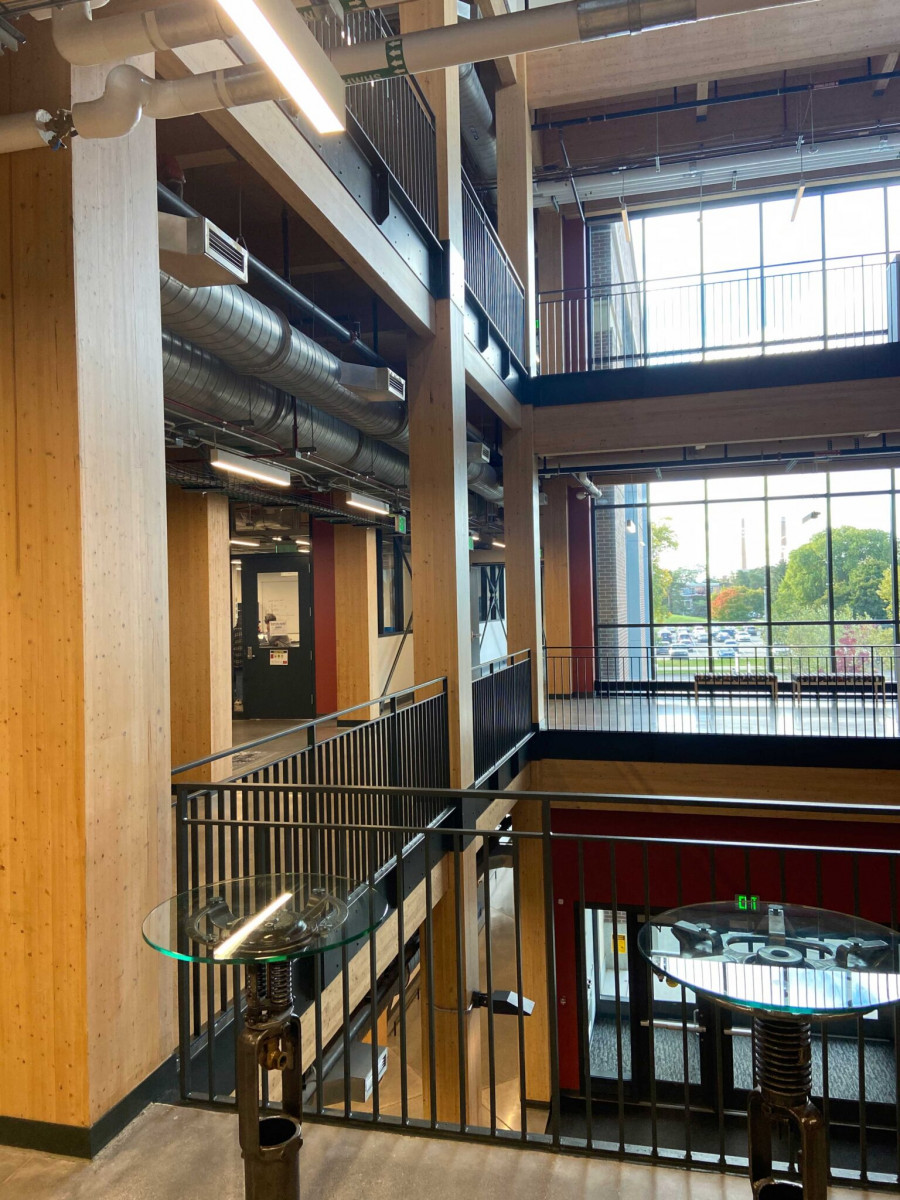 The interior of an academic building where the pillars and walls are made out of mass timber.